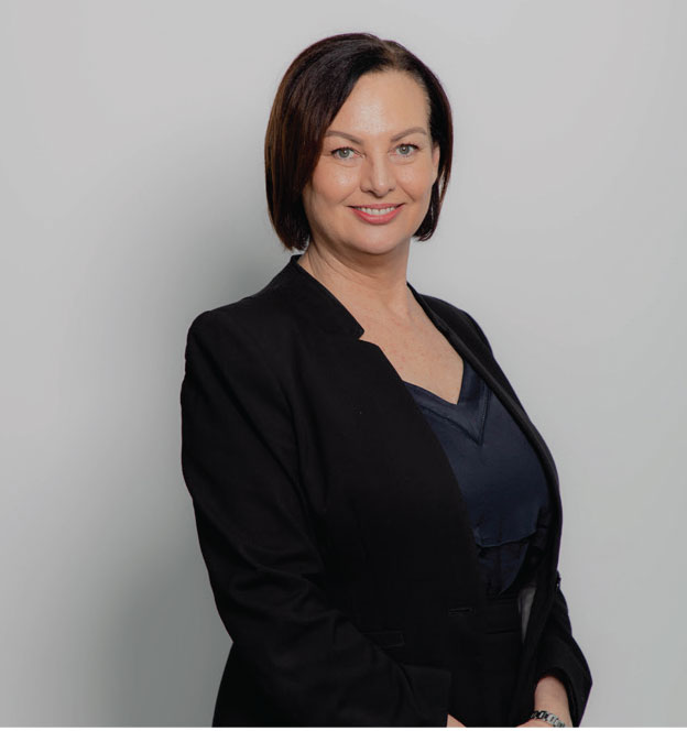 Andrea Lee, member of the Croy Legal team, wearing a professional black suit and smiling in front of a neutral background.